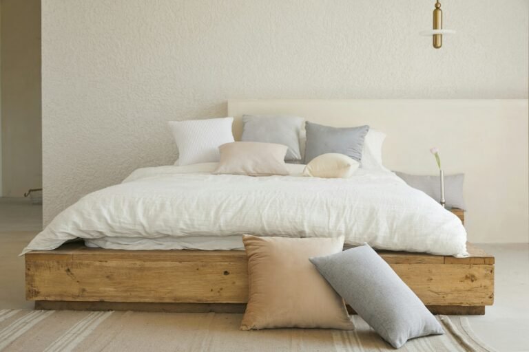White bed with grey and cream pillows