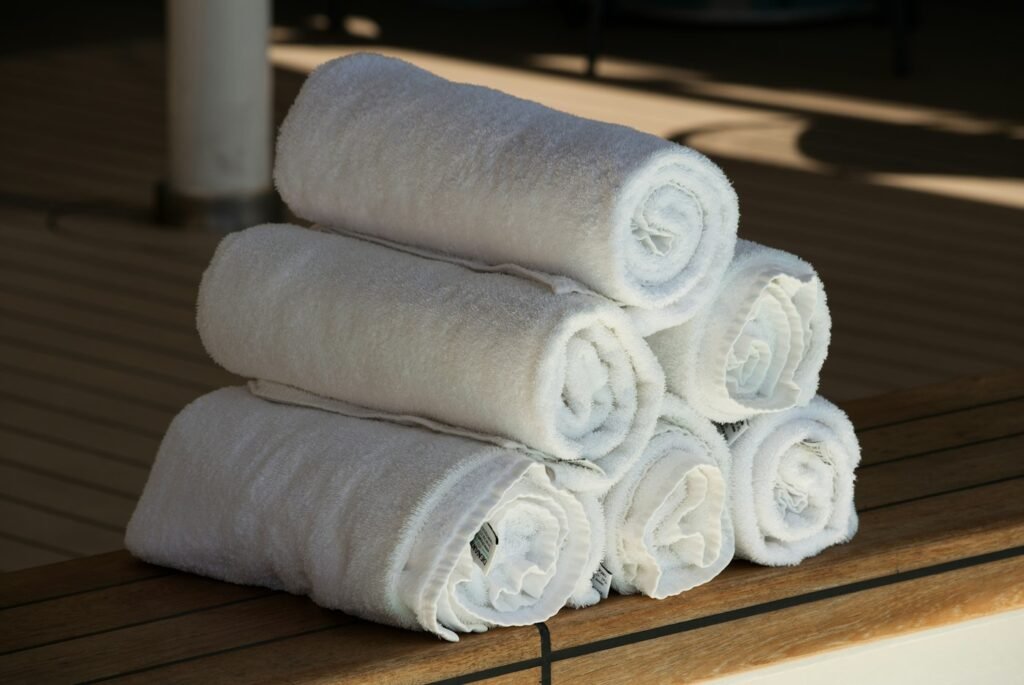 White rolled towels on a wooden surface